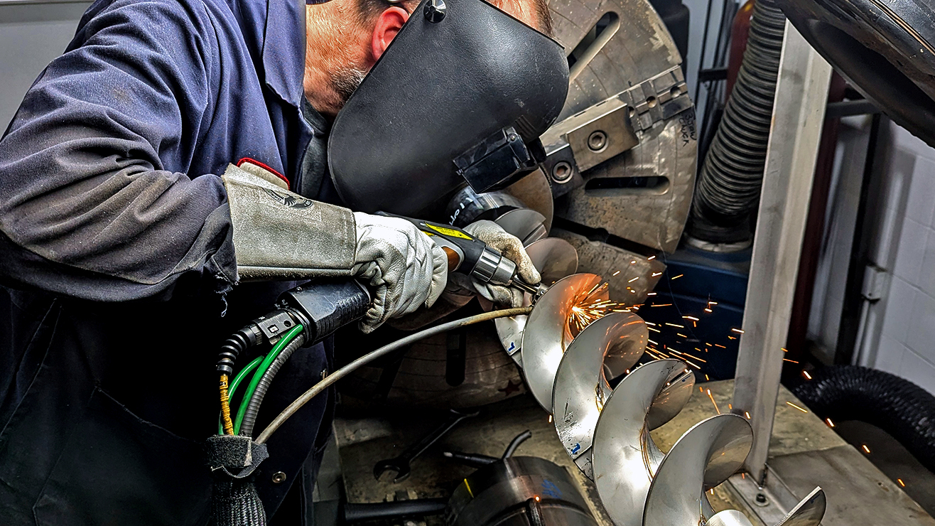 A welder laser welding a spiral part with LightWELD