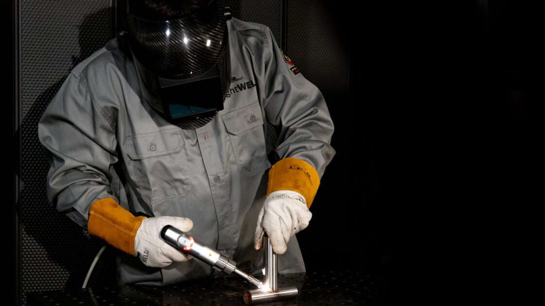 everything-you-need-to-know-about-laser-welding-safety A welder laser welding a part and wearing PPE