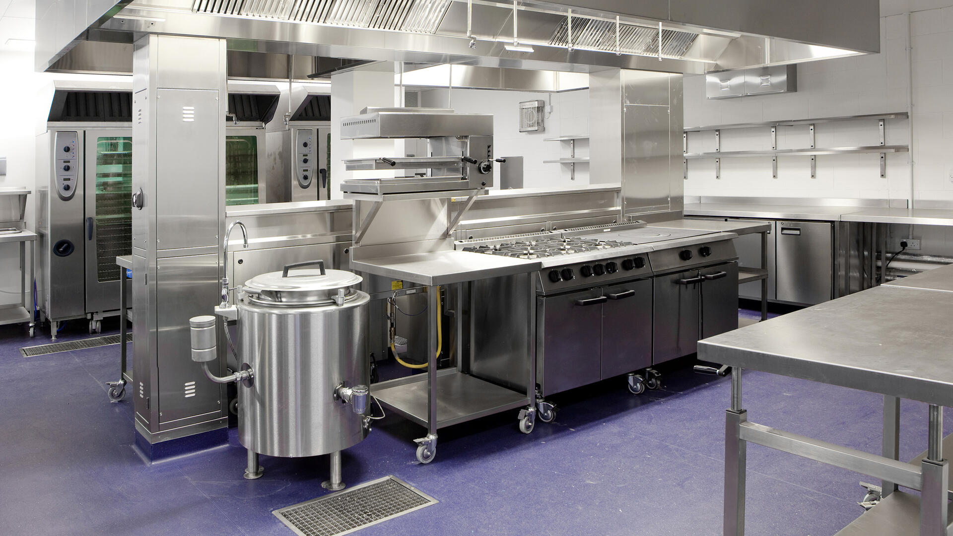 A kitchen with professional food equipment that requires hygienic welds