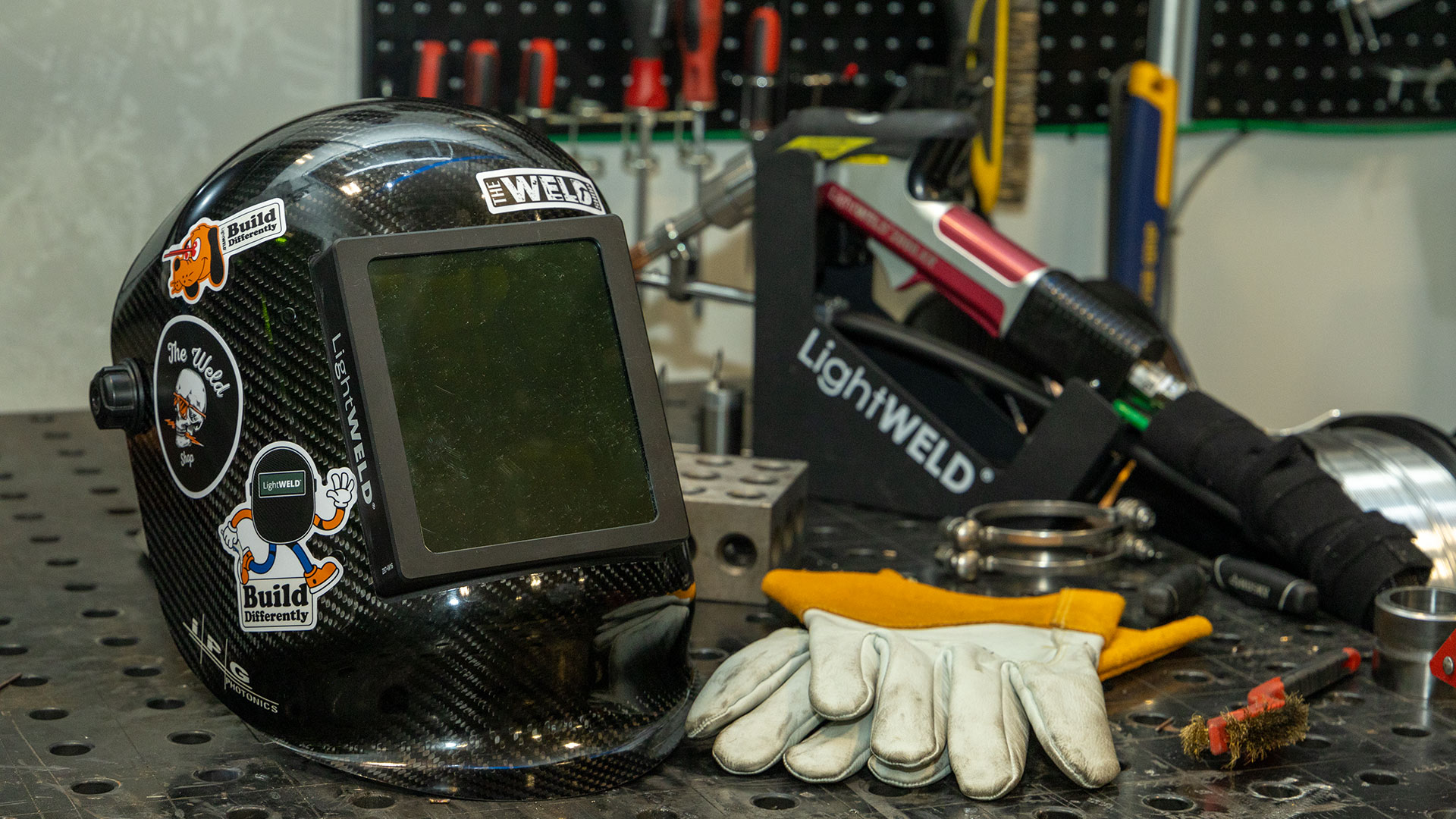 A laser welding helmet on a work table