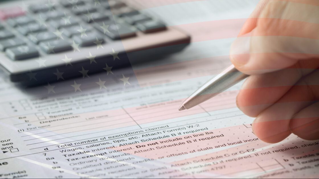 Someone preparing their taxes with an American flag overlay